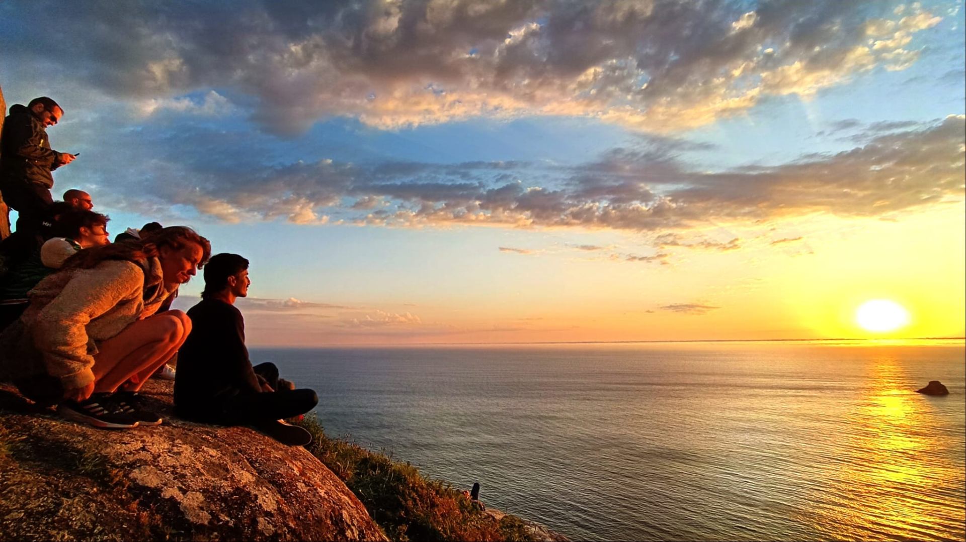 Group watching the sunset over the Atlantic