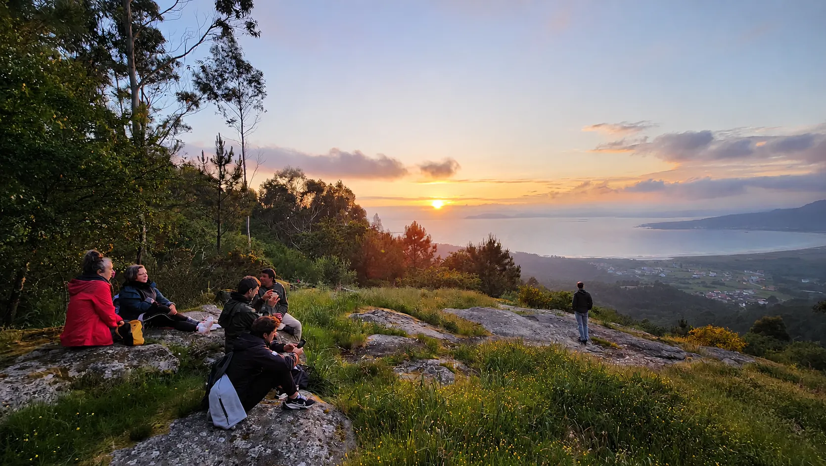 Group watching sunset over the Atlantic from the hills